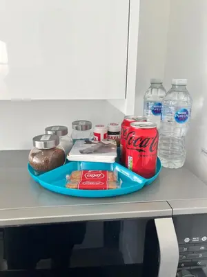 a tray of coke soda and food on a counter at Modern Comfy One Bed Apartment - Free Parking in Glasgow