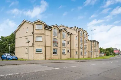 a large brick building on the side of a street at PREMIER - Clydesdale Apartment in Mossend