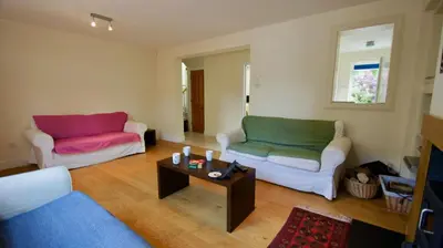 a living room with two couches and a coffee table at Fire Station Cottage in Comrie