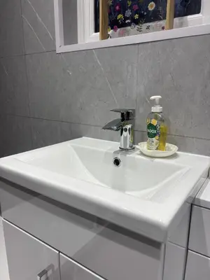 a white sink in a bathroom with a mirror at Morenish Mews Killin Cottage in Morenish