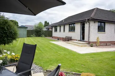 a house with a yard with a lawn sidx sidx sidx at Tomanour in Comrie