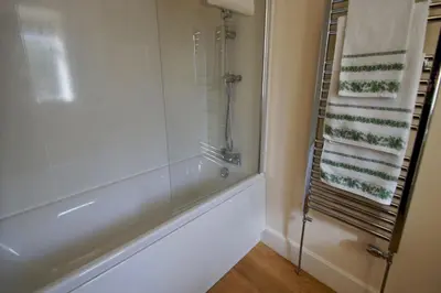 a bathroom with a shower and a glass shower at Waterside in Braco