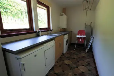 a kitchen with a sink and a washing machine at Osprey View in Lochearnhead