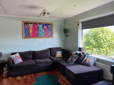 a living room with a couch and a window at Bright, comfy and peaceful house in Inverkeithing