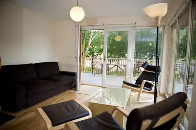 a living room with a couch and chairs at Lochleven Seafood Cottage in Onich