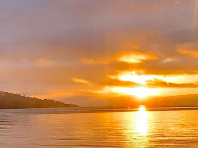 a sunset over a body of water at 2 Bed Cottage Sleeps 2 - Parking Pet Friendly in Dunoon