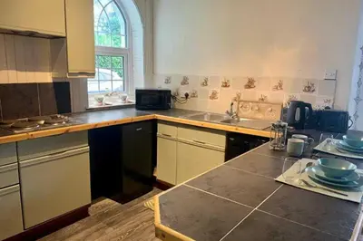 a kitchen with a sink and a counter top at 2 Bed Cottage Sleeps 2 - Parking Pet Friendly in Dunoon