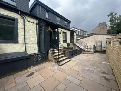 a patio in front of a house with a building at Waverley Apartments, Crow's Nest in Gourock