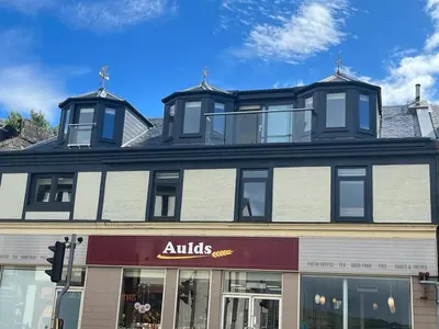 a building with anolis sign on the front of it at Waverley Apartments, Crow's Nest in Gourock