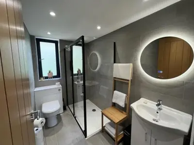 a bathroom with a sink and a toilet and a mirror at Waverley Apartments, Crow's Nest in Gourock