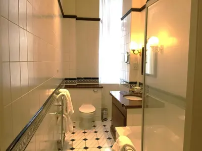 a bathroom with a toilet and a sink at Millennium Hotel Glasgow in Glasgow
