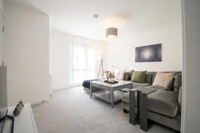 a living room with a couch and a table at Beautiful Glasgow South Home - Pass the Keys in Glasgow
