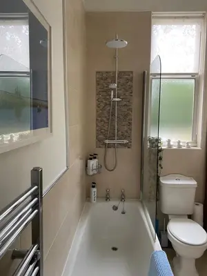 a bathroom with a white tub and a toilet at Tranquil Haven Murrayfield in Edinburgh