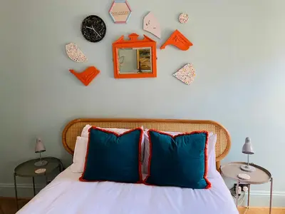 a bedroom with a bed and some clocks on the wall at Ben A'an House in Callander