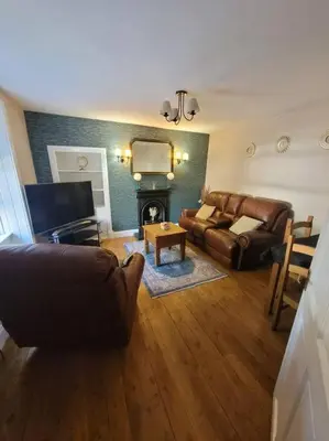 a living room with a couch and a fireplace at 2 Kilkerran Road in Campbeltown
