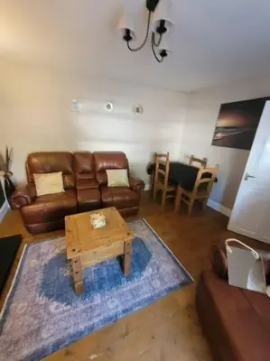 a living room with a couch and a coffee table at 2 Kilkerran Road in Campbeltown