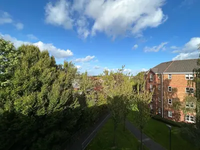 a view of a street with trees and a building at Spekman's 3 Bedroom Ap - 20min Glasgow & Edinburgh in Falkirk