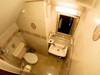 a bathroom with a sink and a toilet and a mirror at Corstorphine Lodge Hotel in Edinburgh