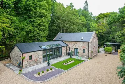an aerial view of a stone house with a garden at The Ultimate Luss Retreat in Luss