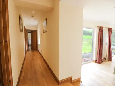 a hallway with a floor to ceiling window at Kilnmark Bothy in Thornhill