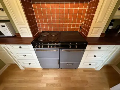 a kitchen with a stove and white cabinets at One Dunbar Court Gleneagles Village in Auchterarder