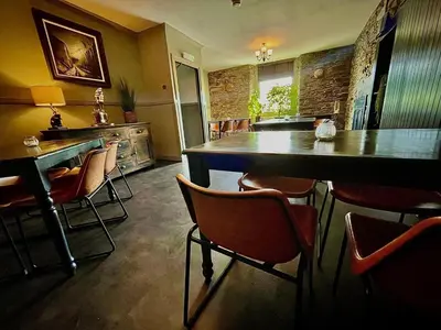 a restaurant with a bar with chairs and a table at The Horseshoe in Lochgilphead