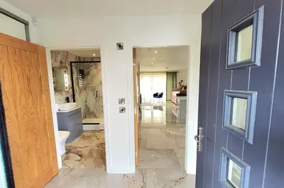 a bathroom with a blue door and a bathroom with a sink at Three Bedrooms House By Sensational Stay Short Lets & Serviced Accommodation With Free Parking & Wi-fi in Ballingry