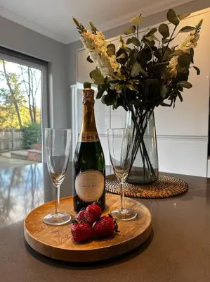 a bottle of wine and two glasses on a table at Luxury Guest House Getaway for 2 in Drymen