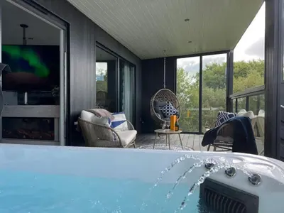 a bath tub with water coming out of it at Loudoun Mains Luxury Lodges in Newmilns
