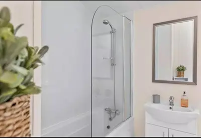 a bathroom with a shower and a sink at Rivers Edge in Dollar