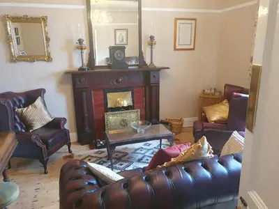 a living room with a couch and a fireplace at The Villa Farmhouse in Cushendun