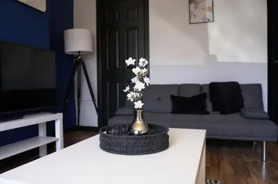 a living room with a vase of flowers on a table at Sauchie House in Sauchie