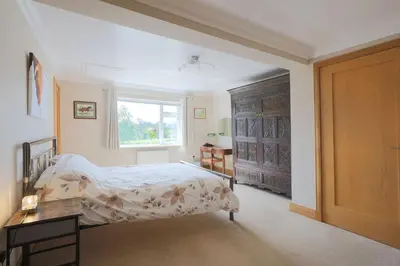 a bedroom with a bed and a window at Teapot Cottage in Newton Stewart