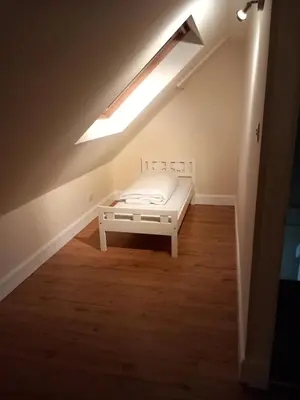 a bedroom with a bed in a room with a skylight at The WEE HOUSE Balvicar Isle of Seil in Balvicar