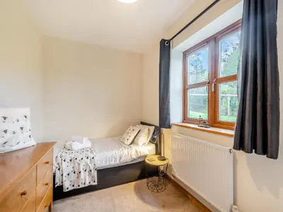 a small bedroom with a bed and a window at South Steading in West Kilbride