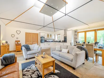 a living room with two couches and a table at South Steading in West Kilbride
