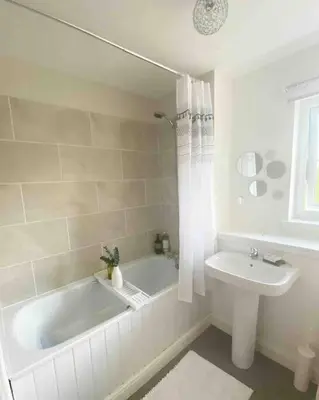 a white bathroom with a tub and a sink at Beautiful cosy 2-bedroom entire house in Connel, near Oban in Connel