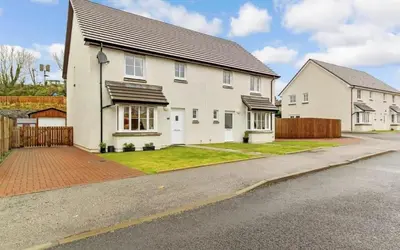 a white house with a fence and a driveway at Beautiful cosy 2-bedroom entire house in Connel, near Oban in Connel