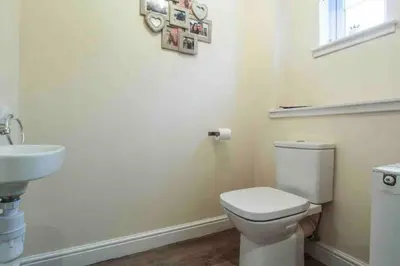 a bathroom with a white toilet and a sink at Beautiful cosy 2-bedroom entire house in Connel, near Oban in Connel