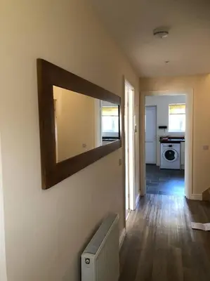 a room with a mirror on the wall with a radiator at Beautiful cosy 2-bedroom entire house in Connel, near Oban in Connel