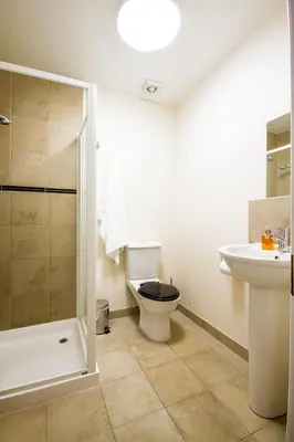 a bathroom with a toilet and a sink at The Arran Lodge & Arran Sleep Huts in Lamlash