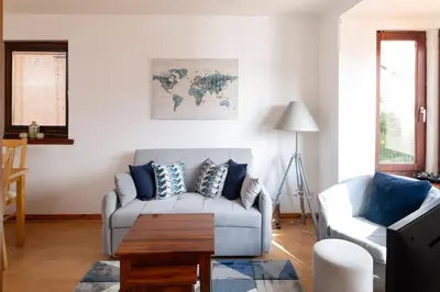 a living room with a couch and a table at Executive Apartment By Inverkeithing Train Station in Fife