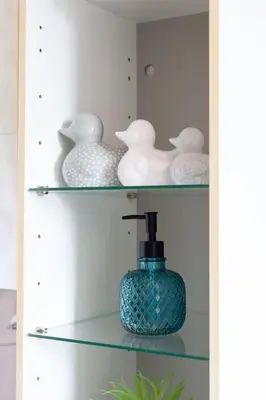 a shelf with vases and a bottle on it at Executive Apartment By Inverkeithing Train Station in Fife