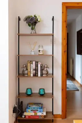 a book shelf in a room with books at Executive Apartment By Inverkeithing Train Station in Fife