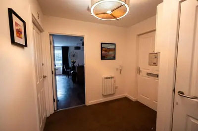 a hallway with a door leading to a living room at Tobermory Apartment in Oban