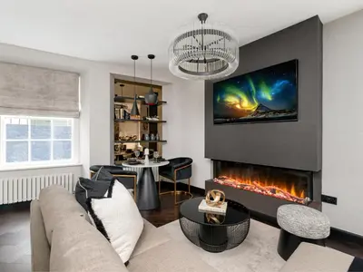 a living room with a couch and a fireplace at Luxury Romantic West-End Apartment With Jacuzzi Spa Bath in Edinburgh