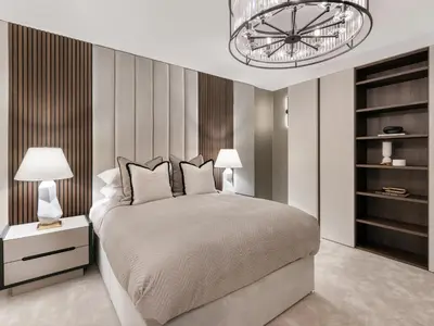 a bedroom with a large bed and a chandelier at Luxury Romantic West-End Apartment With Jacuzzi Spa Bath in Edinburgh