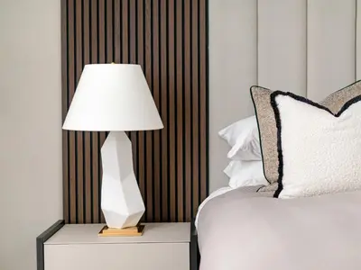 a white lamp sitting on a night stand next to a bed at Luxury Romantic West-End Apartment With Jacuzzi Spa Bath in Edinburgh