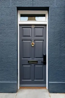 a blue door with a gold knocker on it at Luxury Romantic West-End Apartment With Jacuzzi Spa Bath in Edinburgh