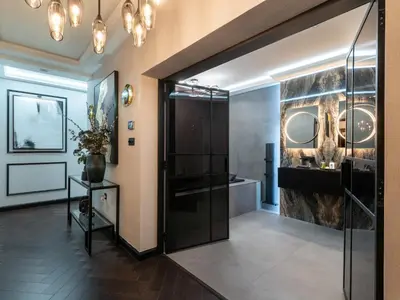 a bathroom with a walk in shower and a glass door at Luxury Romantic West-End Apartment With Jacuzzi Spa Bath in Edinburgh